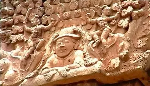 The sculpture with a hat on the vimana.